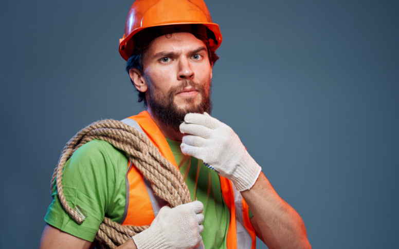 worker in orange reflective vest and hard hat