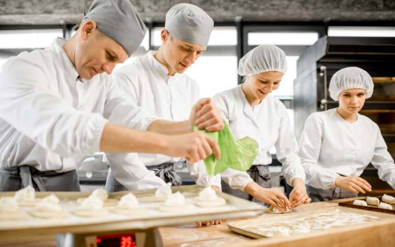 bakery staff in coats and head cover caps